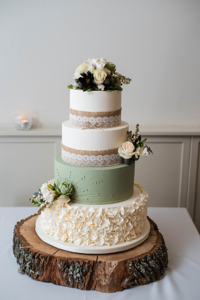 Big wedding cake on wooden slab board